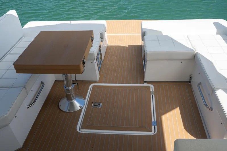  Yacht Photos Pics 2018 Cruisers Yachts 390 Express Coupe deck with seating and table, overlooking water.