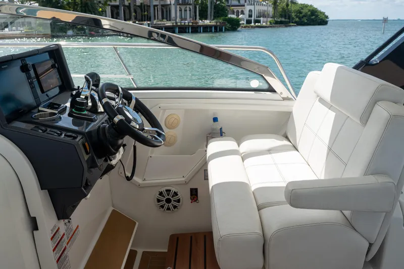  Yacht Photos Pics 2018 Cruisers Yachts 390 Express Coupe helm with luxurious seating and modern controls.