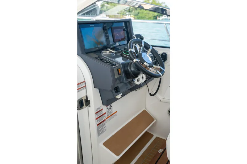  Yacht Photos Pics 2018 Cruisers Yachts 390 Express Coupe helm with modern navigation displays.