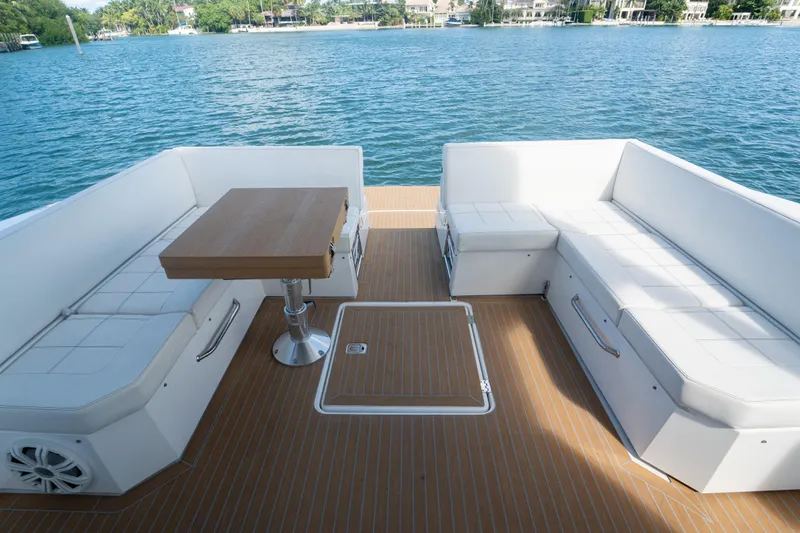  Yacht Photos Pics 2018 Cruisers Yachts 390 Express Coupe deck with seating and table, overlooking serene water.