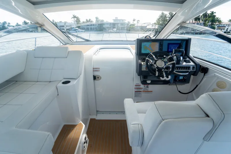  Yacht Photos Pics 2018 Cruisers Yachts 390 Express Coupe helm with modern navigation system and luxurious seating.