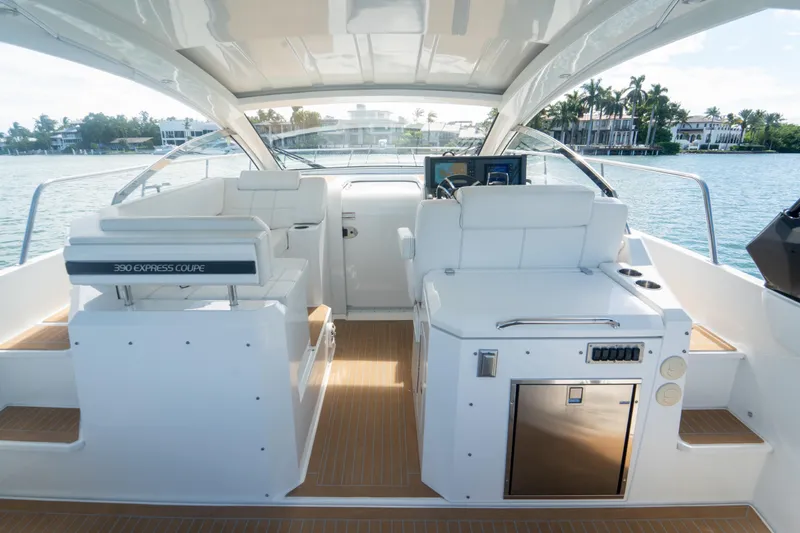  Yacht Photos Pics 2018 Cruisers Yachts 390 Express Coupe interior with helm, seating, and water view.