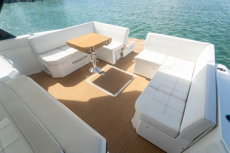  Yacht Photos Pics 2018 Cruisers Yachts 390 Express Coupe with spacious deck seating and table, overlooking water.