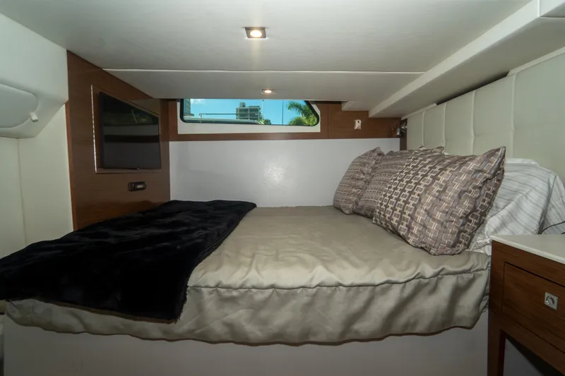  Yacht Photos Pics 2018 Cruisers Yachts 390 Express Coupe cabin with bed, window, and modern decor.