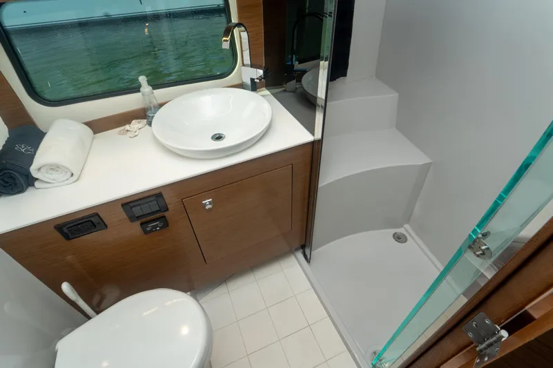  Yacht Photos Pics Luxurious bathroom in 2018 Cruisers Yachts 390 Express Coupe with modern fixtures and shower.