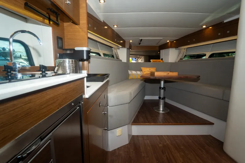  Yacht Photos Pics Luxurious interior of 2018 Cruisers Yachts 390 Express Coupe with modern kitchen and seating area.