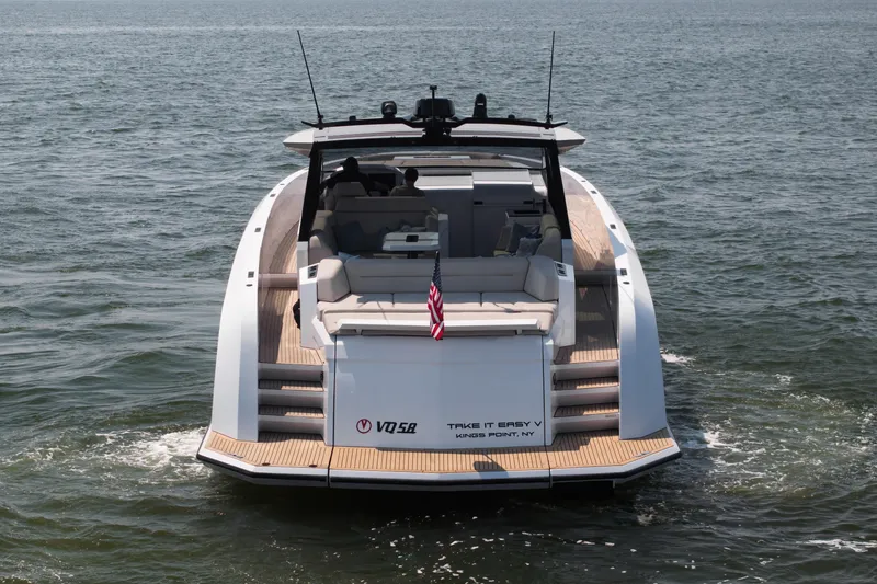 Take It Easy V Yacht Photos Pics 2022 Vanquish VQ58 yacht cruising on open water, rear view.