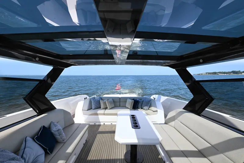 Take It Easy V Yacht Photos Pics Luxurious 2022 Vanquish VQ58 yacht interior with ocean view and elegant seating.