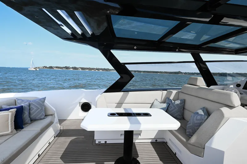 Take It Easy V Yacht Photos Pics Luxurious 2022 Vanquish VQ58 yacht interior with elegant seating and ocean view.