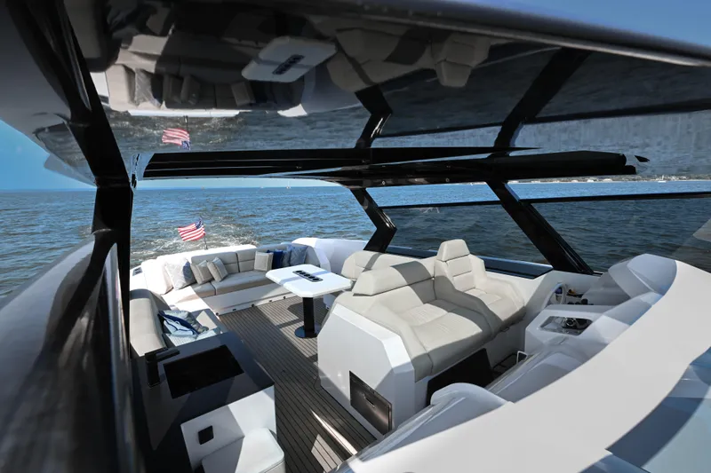 Take It Easy V Yacht Photos Pics Luxurious 2022 Vanquish VQ58 yacht interior with sleek seating and ocean view.