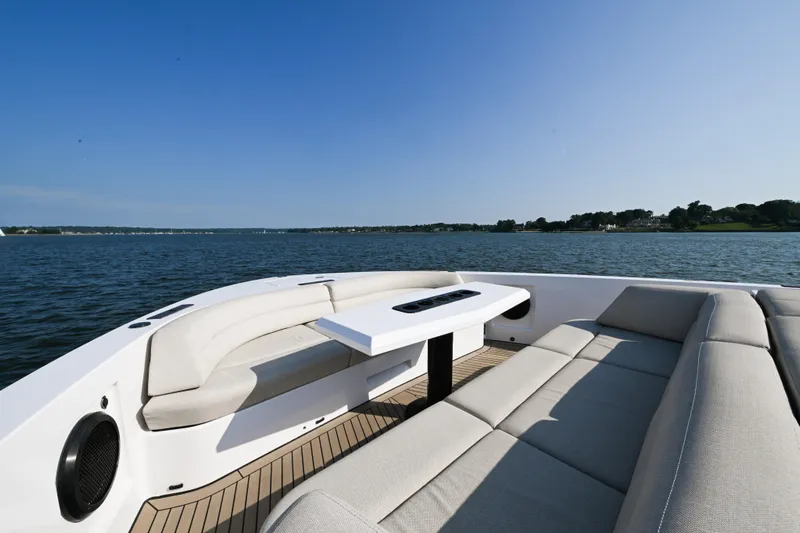 Take It Easy V Yacht Photos Pics Luxurious 2022 Vanquish VQ58 yacht with elegant seating on a serene lake.
