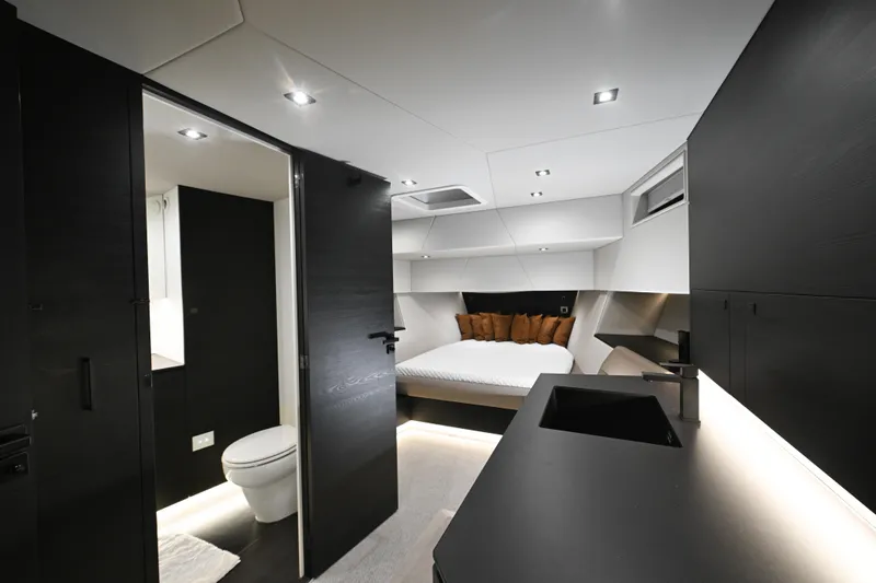 Take It Easy V Yacht Photos Pics Luxurious interior of 2022 Vanquish VQ58 yacht featuring modern bedroom and bathroom.