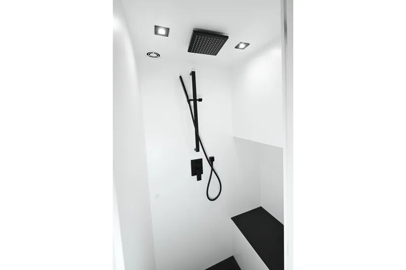 Take It Easy V Yacht Photos Pics Modern shower in 2022 Vanquish VQ58 yacht, featuring sleek black fixtures and minimalist design.