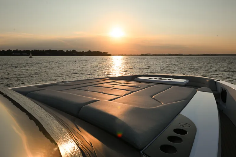 Take It Easy V Yacht Photos Pics Sunset view from 2022 Vanquish VQ58 yacht deck on tranquil water.