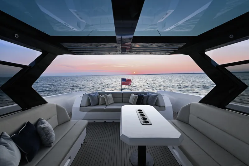 Take It Easy V Yacht Photos Pics Luxurious 2022 Vanquish VQ58 yacht interior with ocean view at sunset.