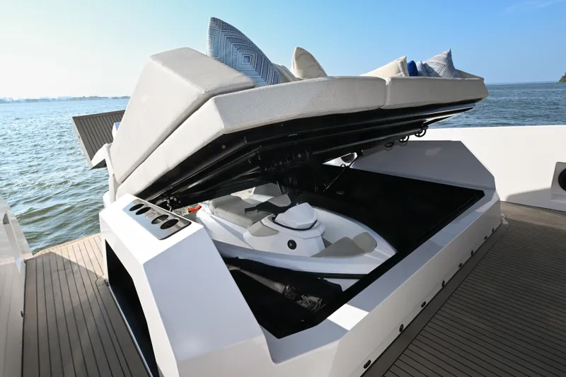 Take It Easy V Yacht Photos Pics 2022 Vanquish VQ58 yacht with open storage compartment, revealing a jet ski.