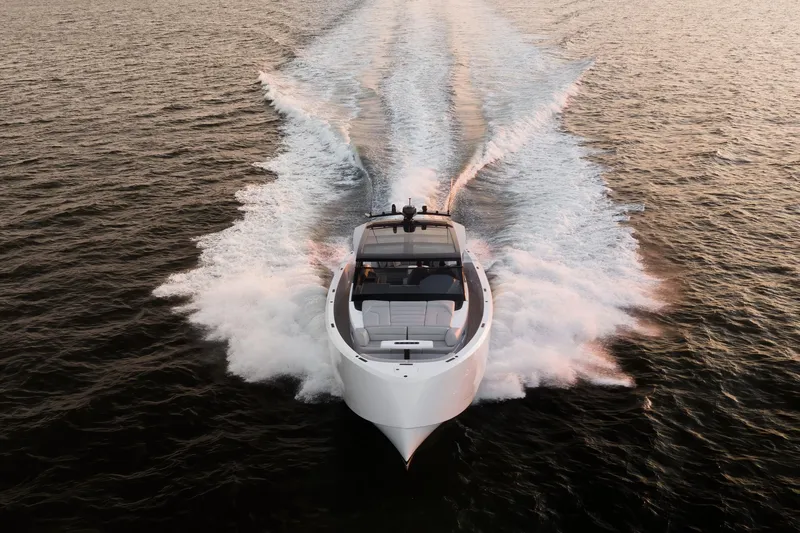 Take It Easy V Yacht Photos Pics Vanquish VQ58 yacht cruising on open water at sunset, 2022 model.