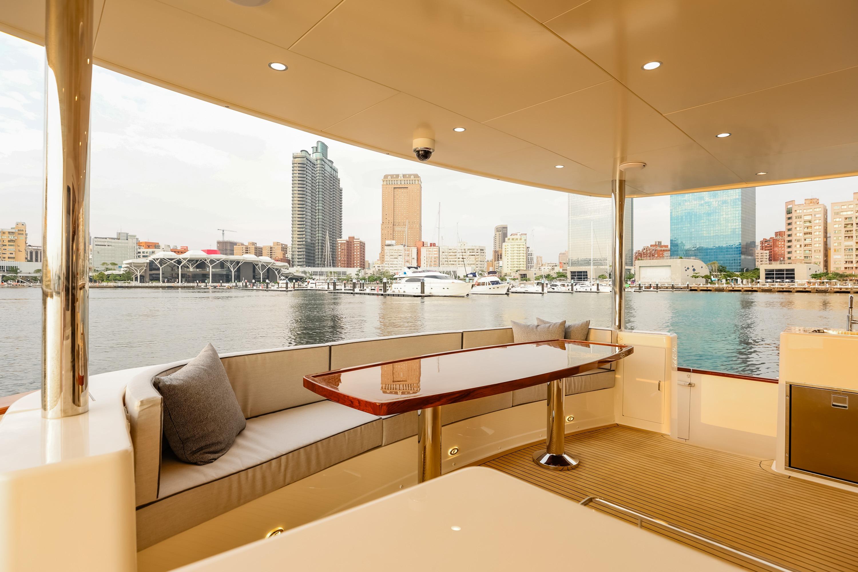 Luxurious 2027 Fleming 85 Pilothouse yacht with city skyline view.