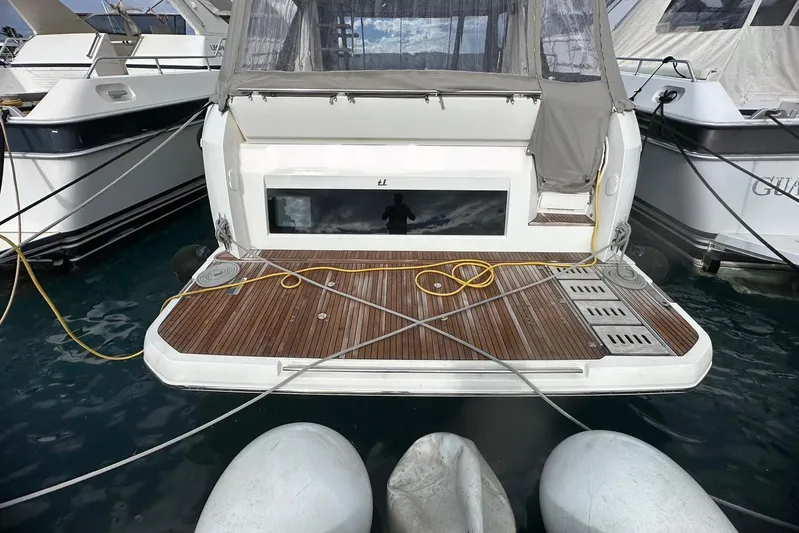  Yacht Photos Pics Rear view of a 2018 Prestige 520 yacht docked at a marina.