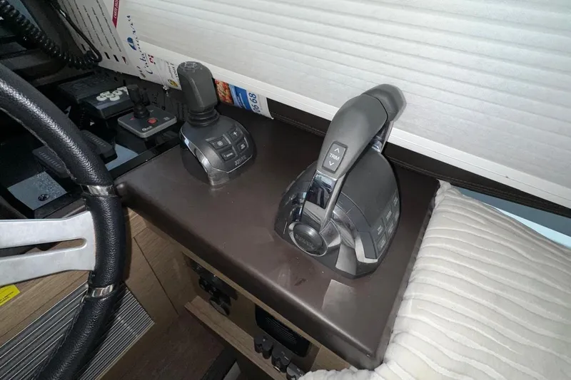  Yacht Photos Pics Control panel of a 2018 Prestige 520 yacht with steering wheel and throttle levers.