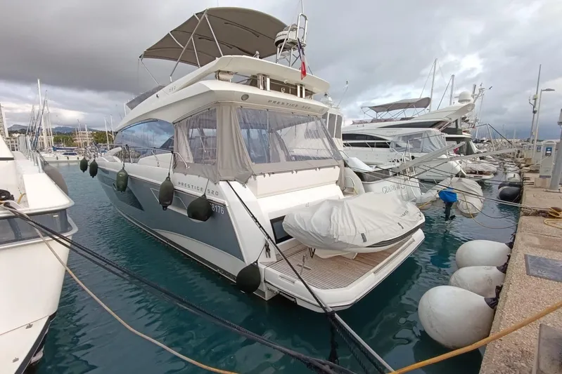  Yacht Photos Pics Luxury 2018 Prestige 520 yacht docked at marina, surrounded by other boats.