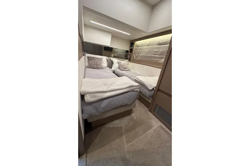  Yacht Photos Pics Luxurious twin bedroom in 2018 Prestige 520 yacht, featuring modern decor and cozy bedding.
