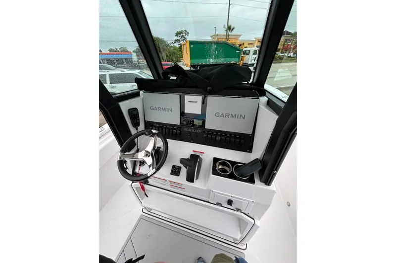  Yacht Photos Pics 2025 Blackfin 252 CC boat dashboard with Garmin navigation system and steering wheel.