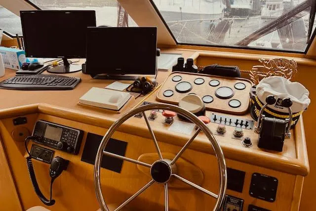 "robyn Faye" Yacht Photos Pics 1996 Forbes Cooper pilot house interior with steering wheel, control panels, and navigation equipment.