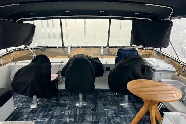 "robyn Faye" Yacht Photos Pics 1996 Forbes Cooper pilot house interior with covered seats and wooden table.