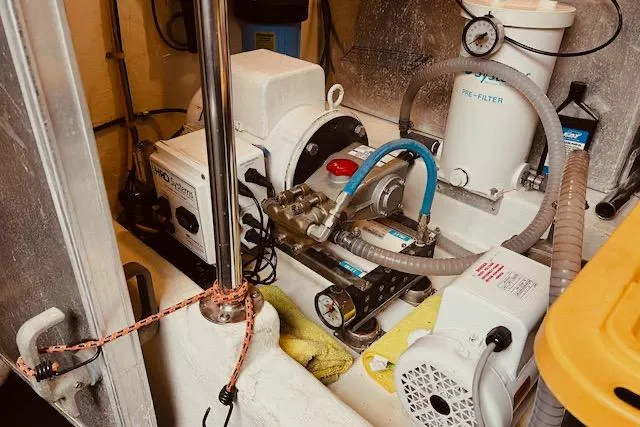 "robyn Faye" Yacht Photos Pics Engine room of a 1996 Forbes Cooper pilot house boat, featuring mechanical equipment and hoses.