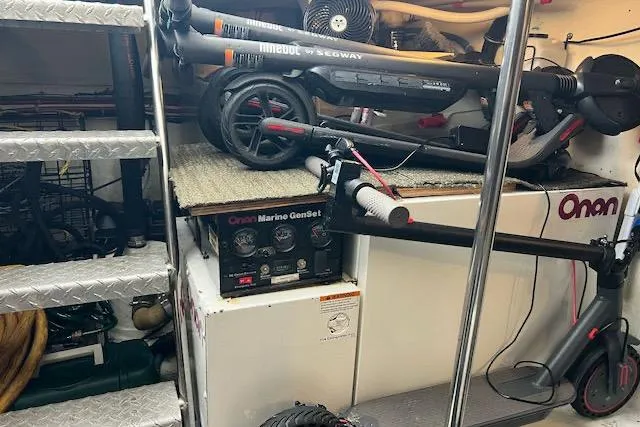 "robyn Faye" Yacht Photos Pics Storage area in a 1996 Forbes Cooper pilot house with scooters and Onan Marine GenSet.