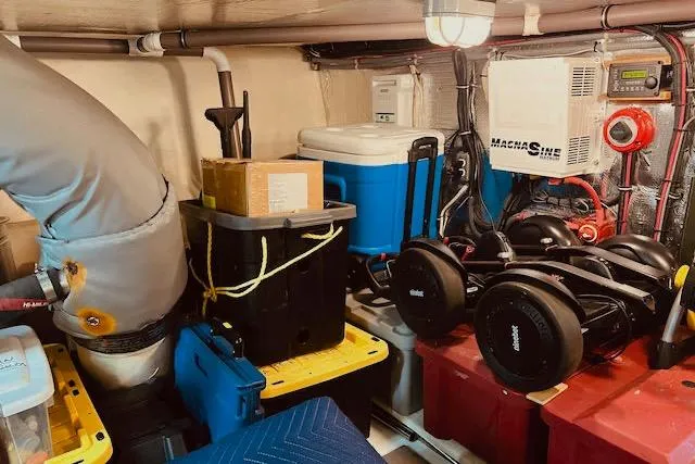 "robyn Faye" Yacht Photos Pics Engine room of a 1996 Forbes Cooper pilot house, featuring equipment and storage containers.