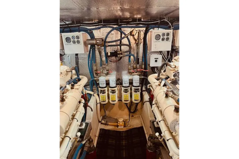 "robyn Faye" Yacht Photos Pics Engine room of a 1996 Forbes Cooper pilot house boat, featuring complex machinery and controls.