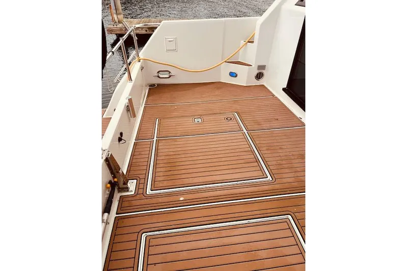 "robyn Faye" Yacht Photos Pics 1996 Forbes Cooper pilot house boat deck with teak flooring and dock view.