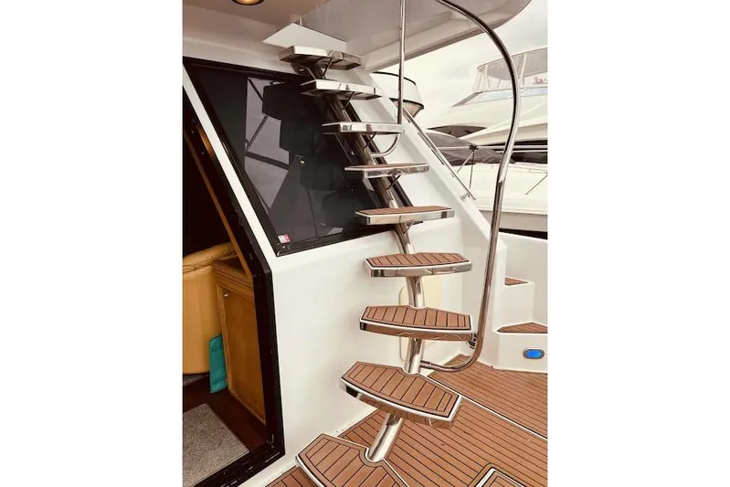 "robyn Faye" Yacht Photos Pics Staircase on 1996 Forbes Cooper pilot house yacht with wooden steps and sleek design.
