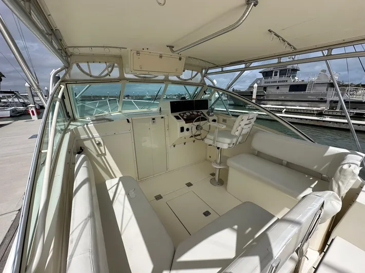  Yacht Photos Pics 2006 Albemarle 320 Express Fisherman boat interior with helm station and seating.