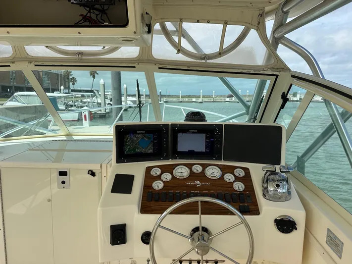  Yacht Photos Pics 2006 Albemarle 320 Express Fisherman boat helm with navigation instruments and steering wheel.