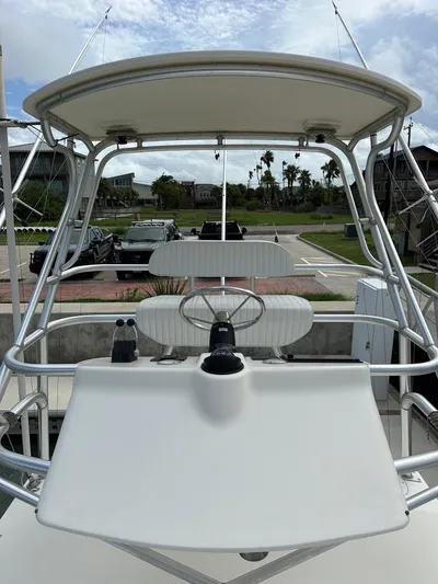  Yacht Photos Pics 2006 Albemarle 320 Express Fisherman boat with a white helm station and canopy.