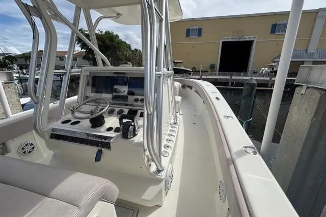  Yacht Photos Pics 2016 SeaVee 34 boat cockpit with steering wheel and navigation equipment at a marina.