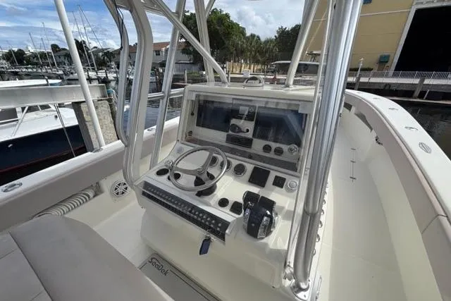  Yacht Photos Pics 2016 SeaVee 34 boat console with steering wheel and navigation equipment at marina.