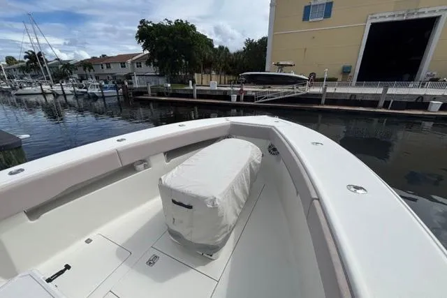  Yacht Photos Pics 2016 SeaVee 34 boat docked at marina, featuring spacious deck and covered seating.