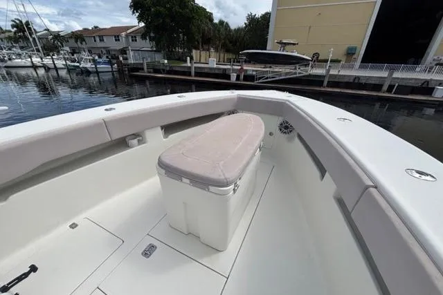  Yacht Photos Pics 2016 SeaVee 34 boat with cushioned seating, docked in a marina.