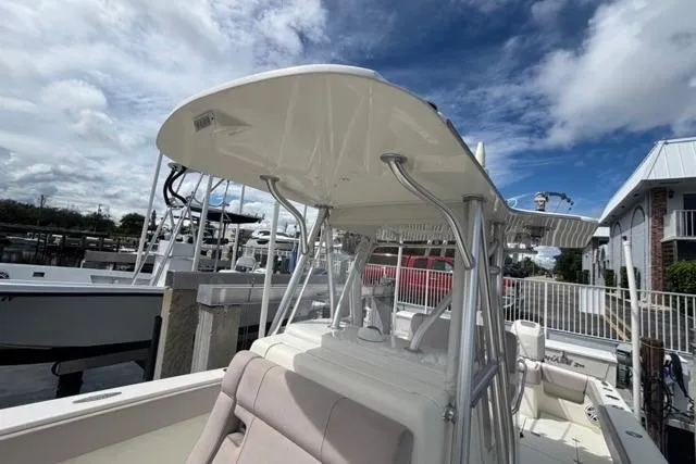  Yacht Photos Pics 2016 SeaVee 34 boat with T-top, docked under a partly cloudy sky.