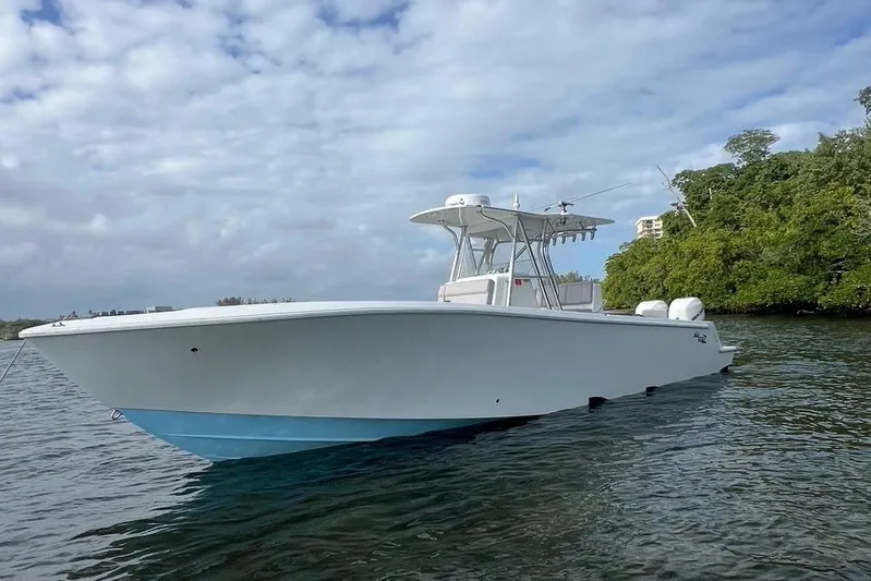  Yacht Photos Pics 2016 SeaVee 34 boat on water, clear sky, lush greenery in background.