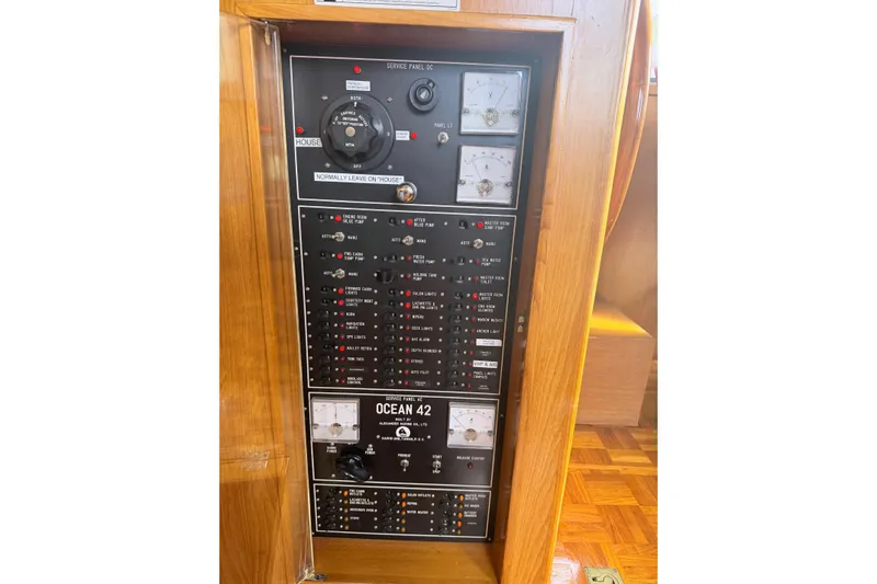  Yacht Photos Pics Electrical control panel of a 1988 Ocean Alexander 42' yacht, featuring various switches and gauges.