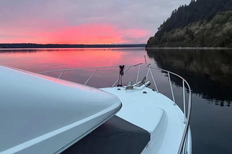  Yacht Photos Pics Ocean Alexander 42' yacht at sunset on calm waters, 1988 model.