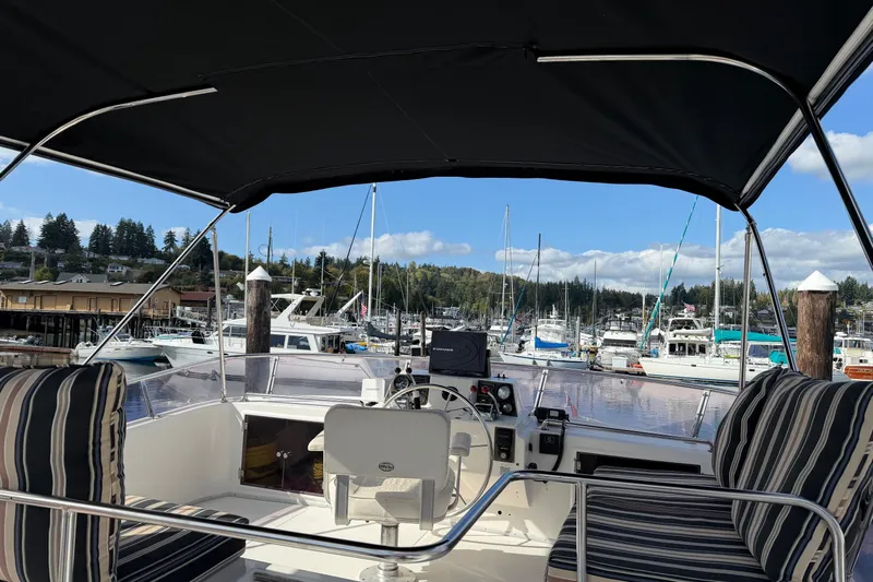  Yacht Photos Pics 1988 Ocean Alexander 42' yacht interior with marina view, featuring striped seating and helm.
