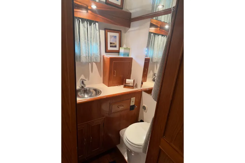  Yacht Photos Pics Bathroom interior of 1988 Ocean Alexander 42' yacht with wood cabinetry and stainless steel sink.