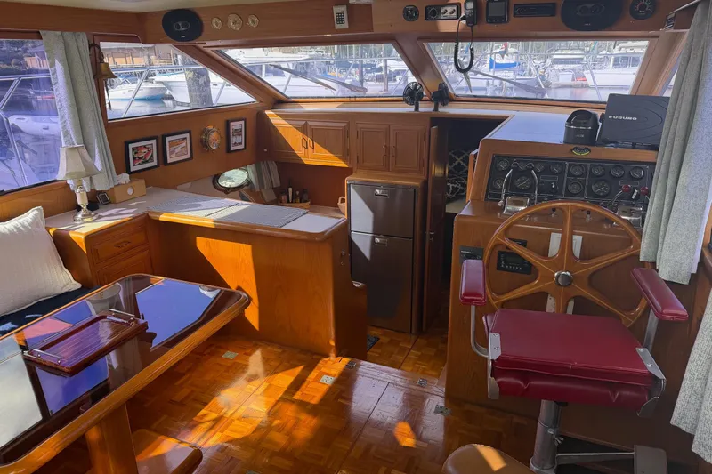  Yacht Photos Pics 1988 Ocean Alexander 42' yacht interior with wooden helm, dining area, and nautical decor.
