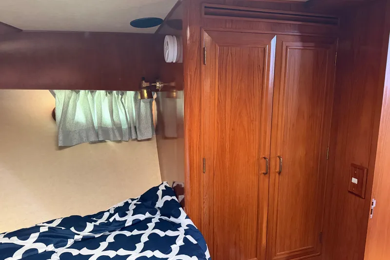  Yacht Photos Pics Interior cabin of 1988 Ocean Alexander 42' yacht with wooden closet and bed.